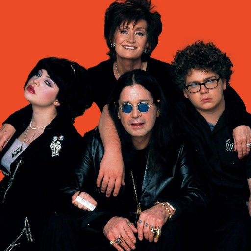 A group of people posing in front of an orange background.